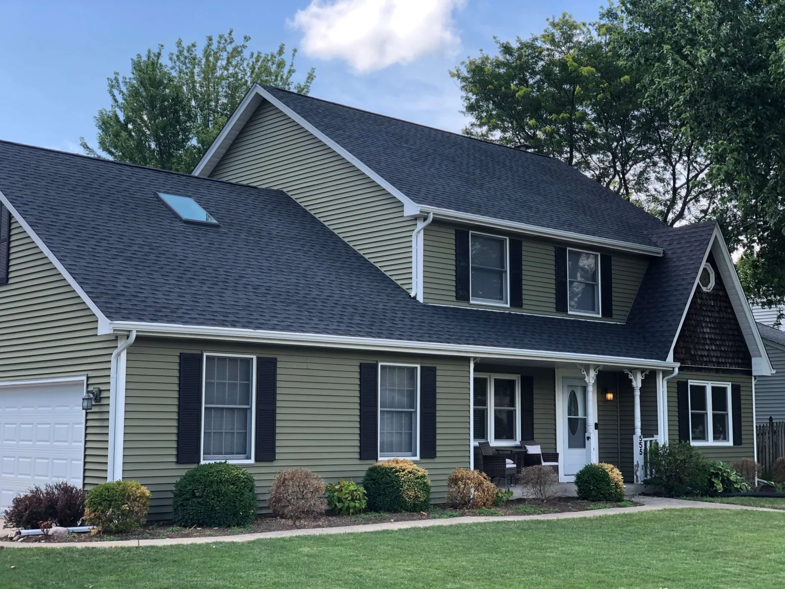 House exterior with a dark roof and white trim